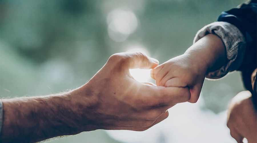 man holding child's hand