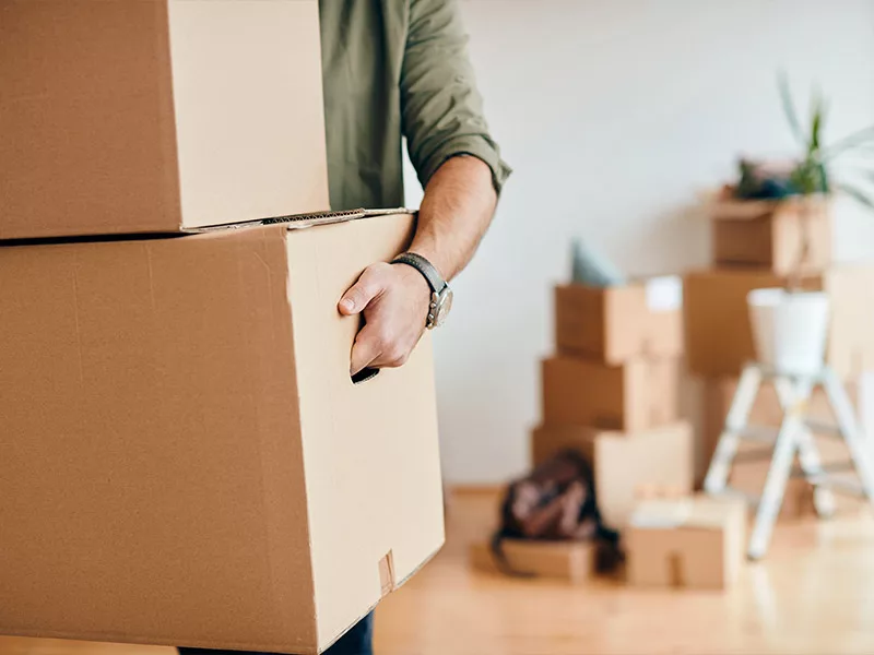 man packing up his belongings in boxes