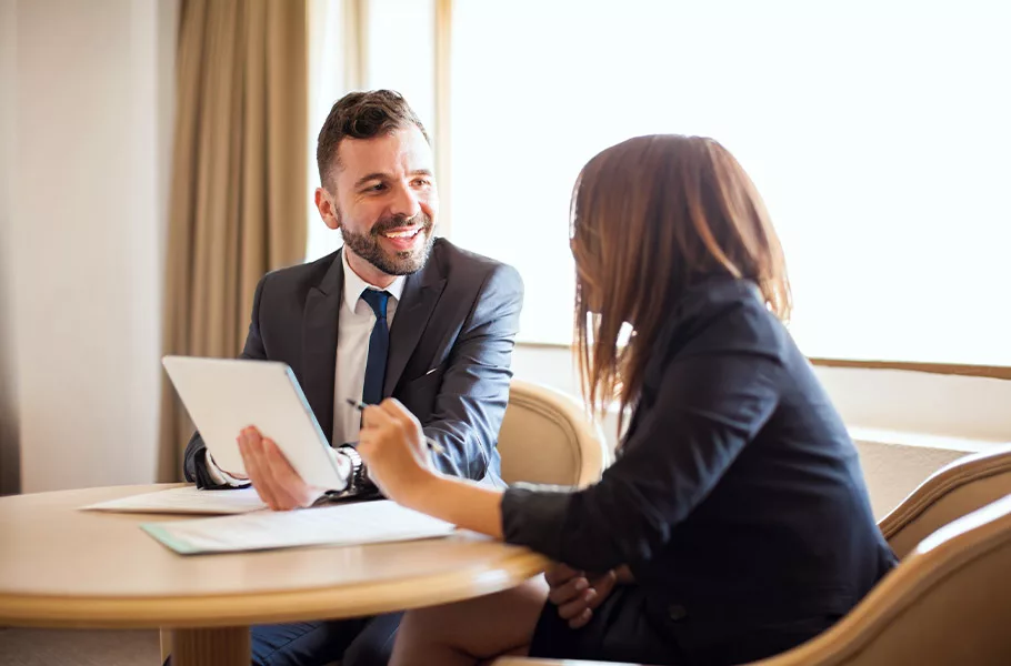 lawyer sitting down talking to a client