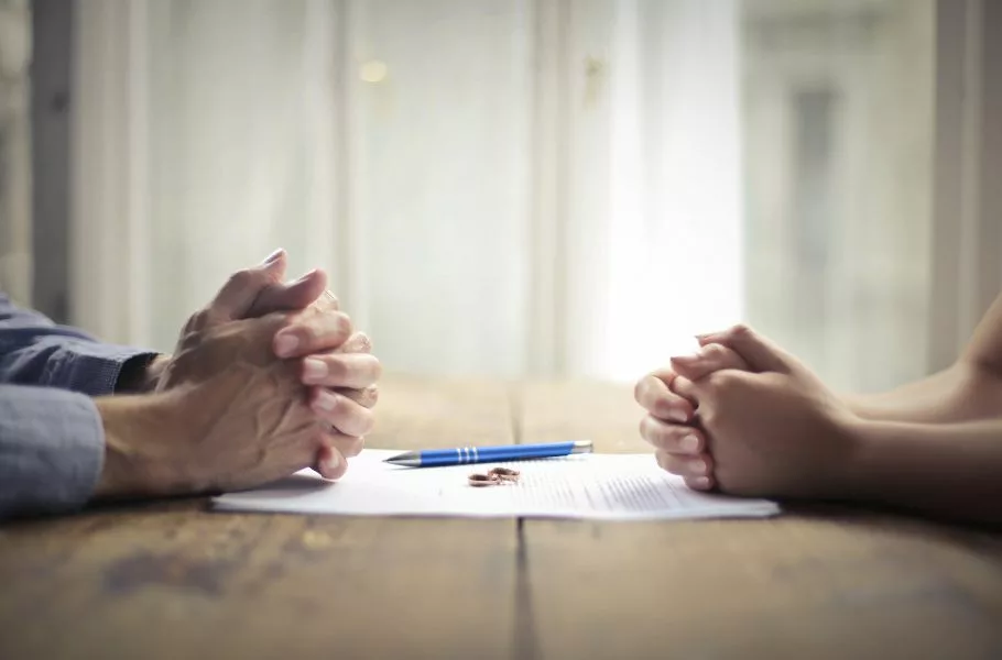 husband and wife signing divorce paperwork