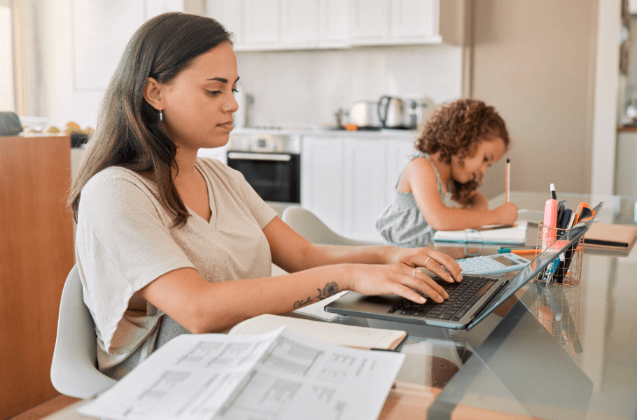 Woman and Child Working at a Desk Together 