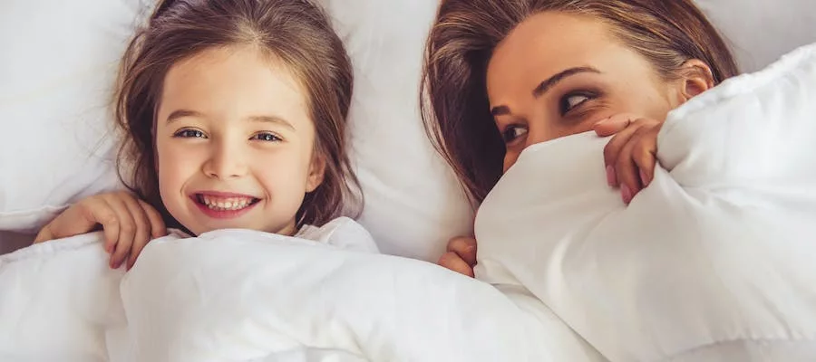 Mother and daughter in bed